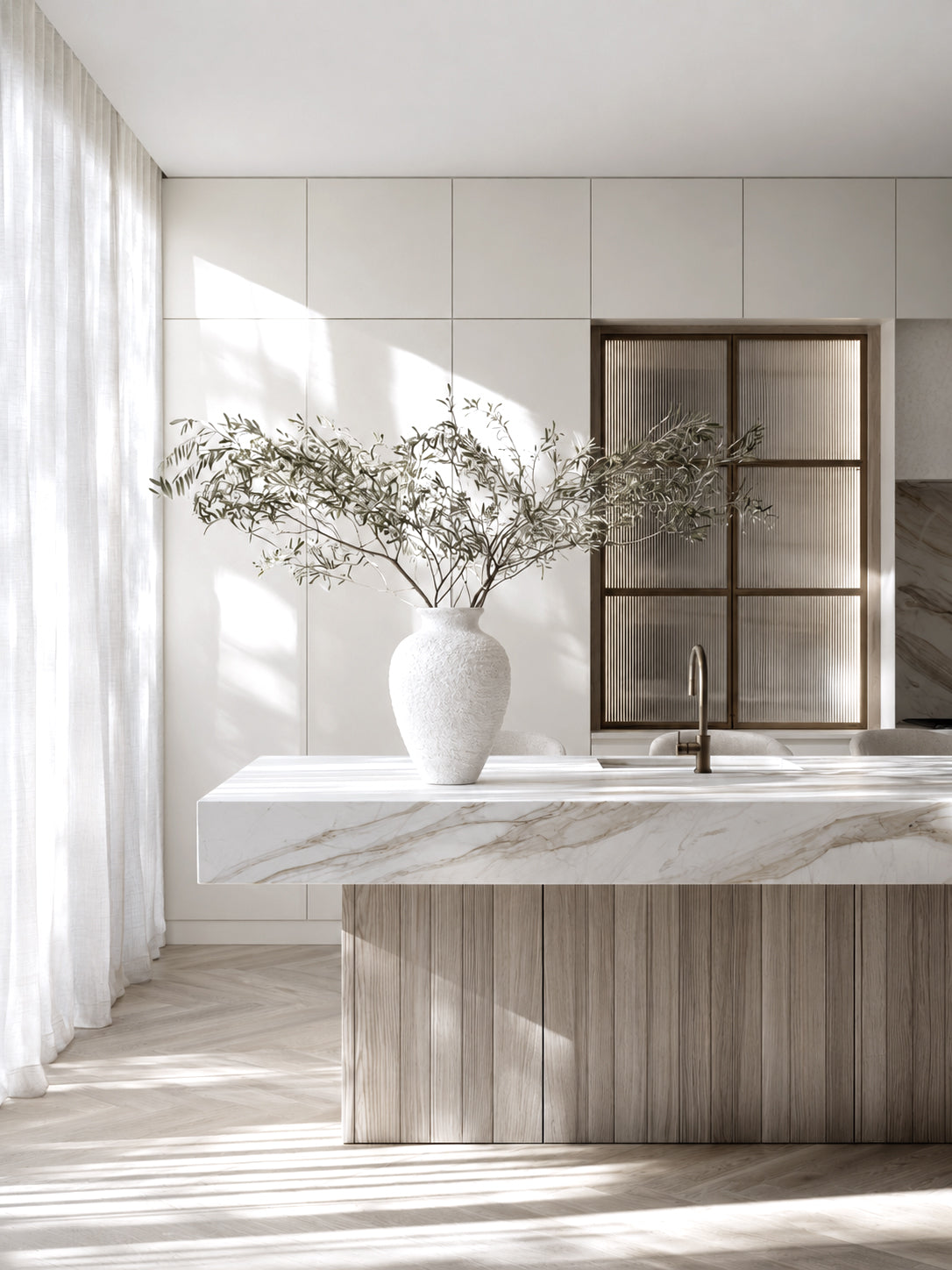Lyra white vase holding a wide spray of olive branches on a marble and timber kitchen island
