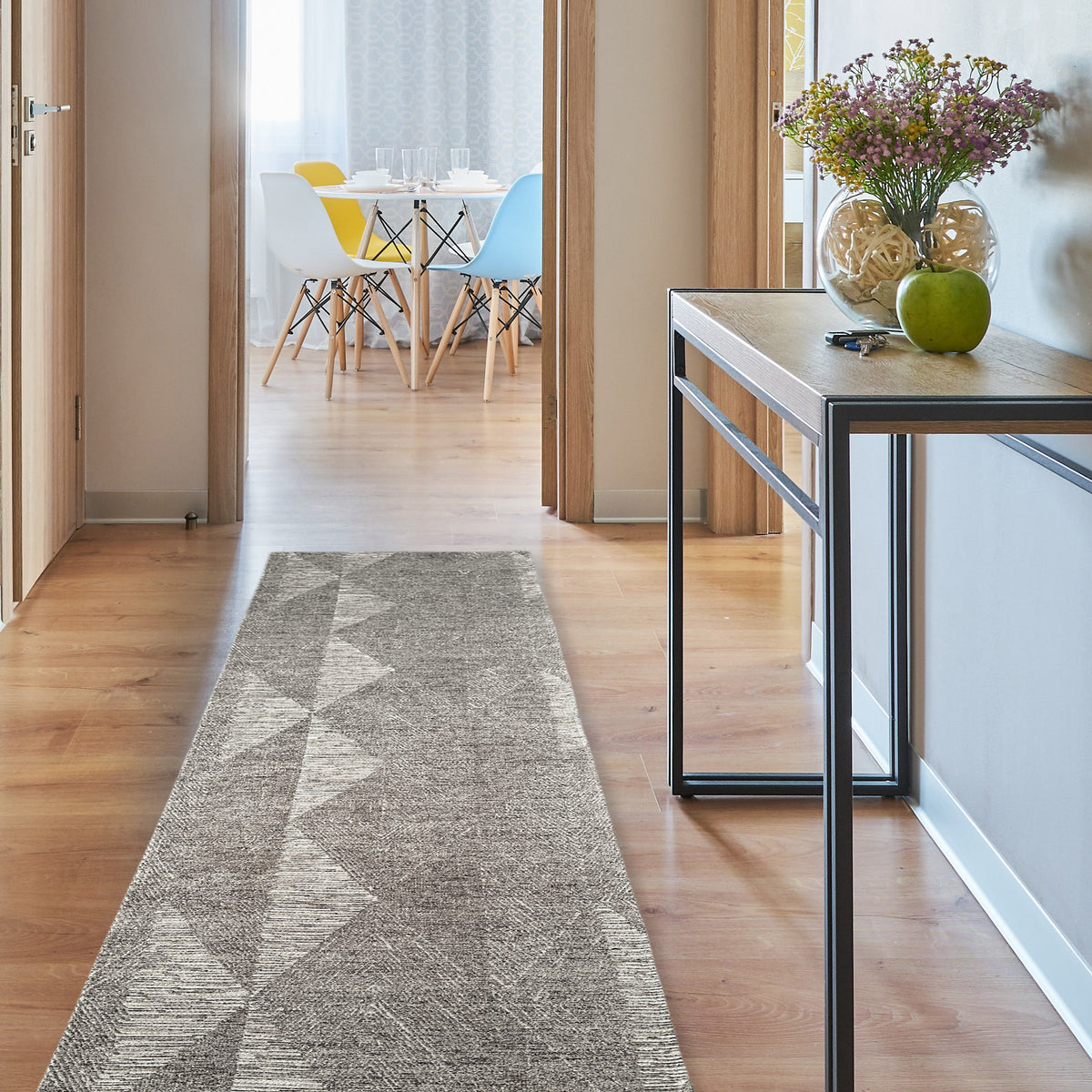 Brown chenille runner along a timber hallway beside a slim console with flowers