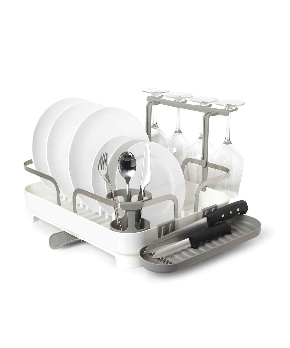 Holster dish rack by Umbra in white with plates, cutlery, wine glasses and a knife in the side tray