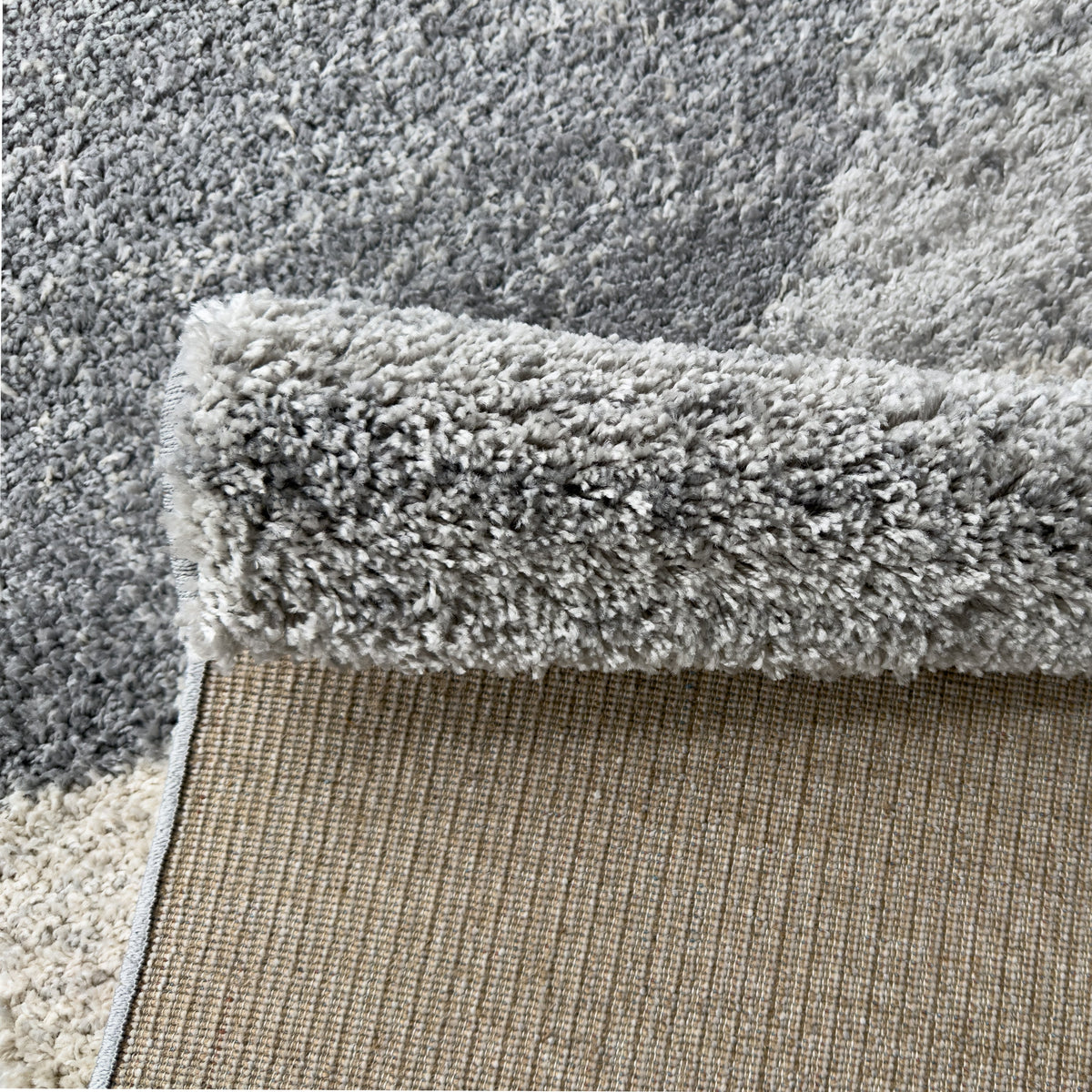 Cloud grey rug folded back to show its woven backing