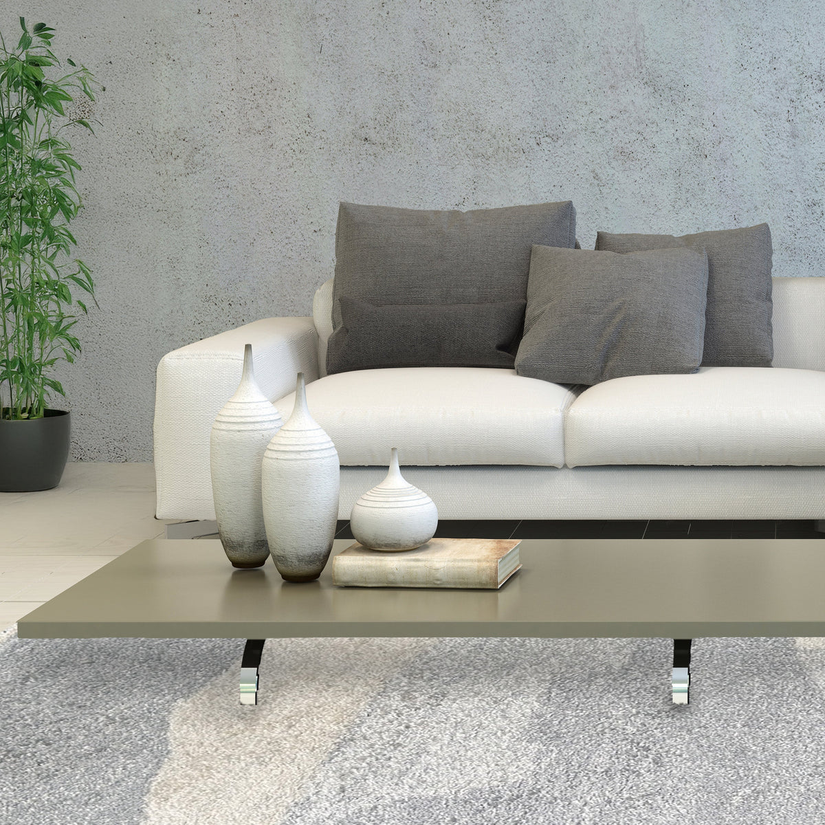 Cloud grey rug under a low coffee table with a white sofa, grey cushions and a concrete wall