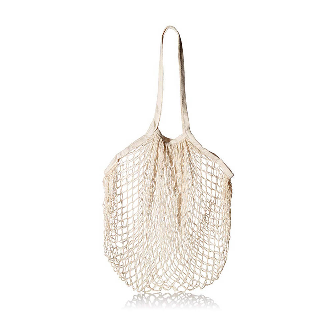 Cream string market bag shown empty and gathered, hanging against a plain white background