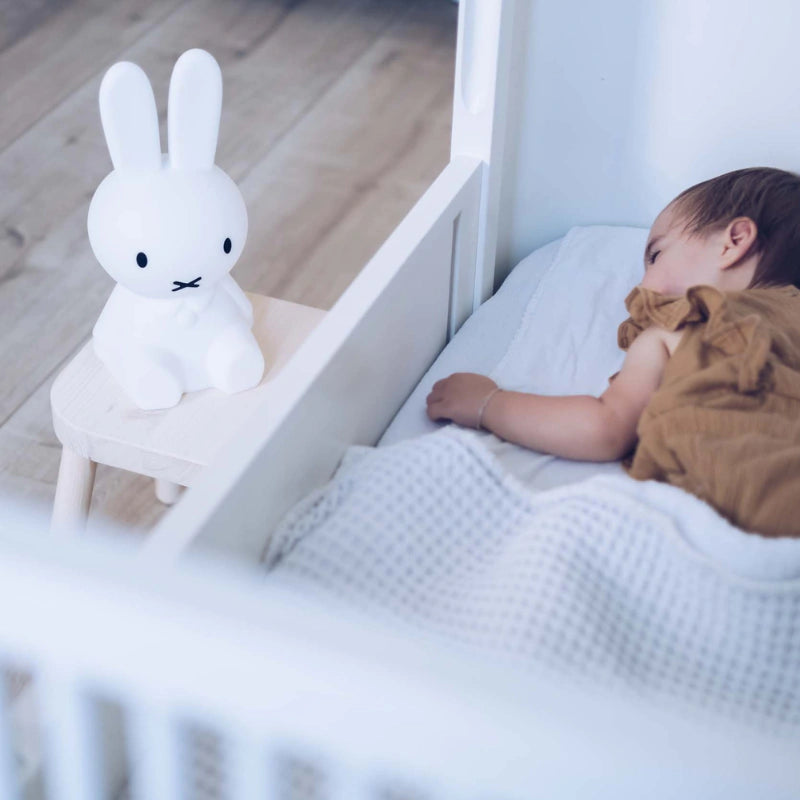 Miffy First Light by Mr Maria on a bedside table beside a sleeping child