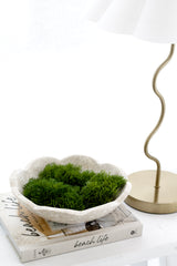 Set of three artificial moss shapes in a scalloped stone bowl on coffee table styling vignette