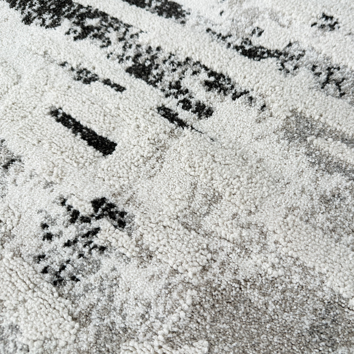 Close view of the grey, black and ivory high-low pile