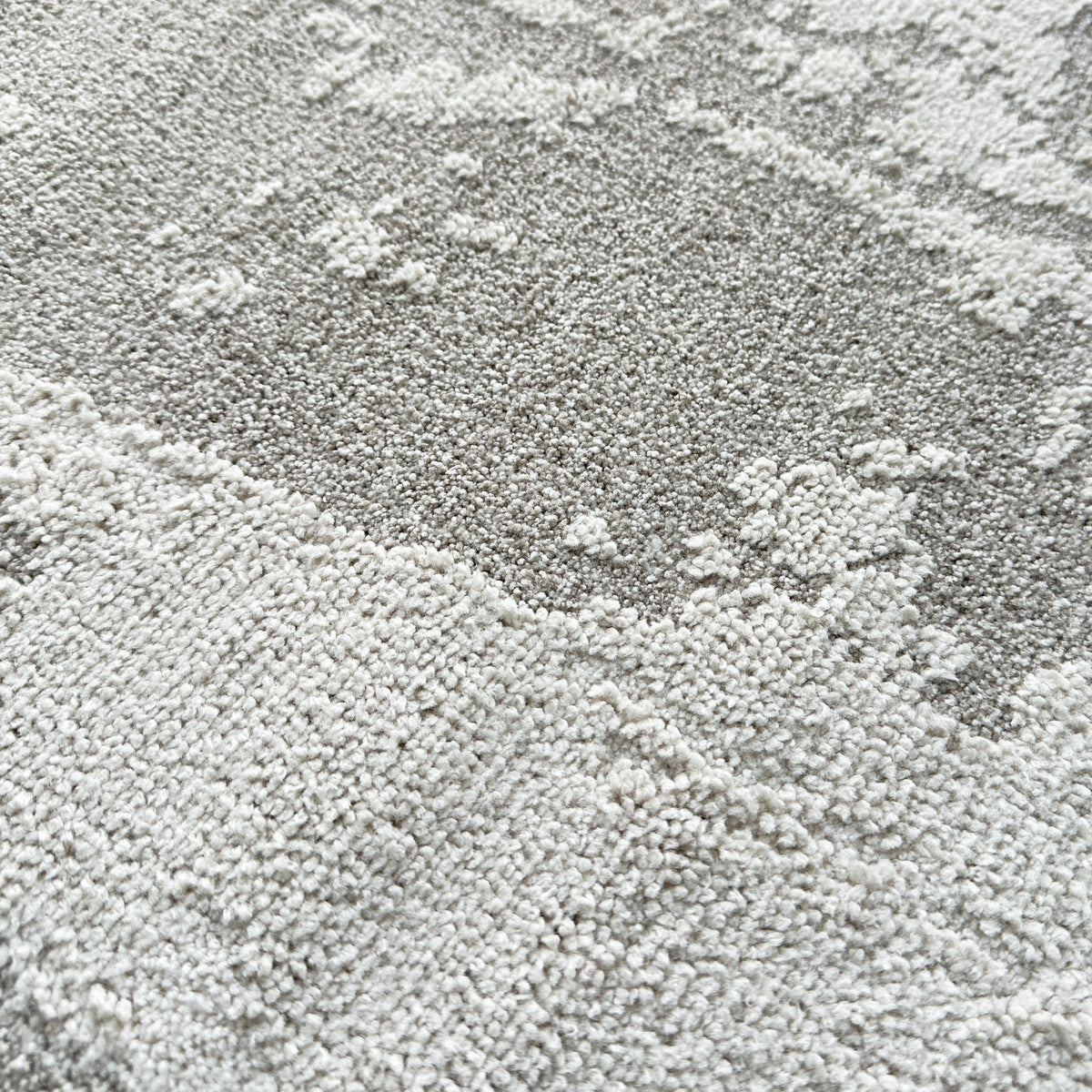 Close view of the grey and beige high-low pile