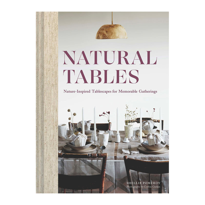 A beautifully styled Natural Tables: Nature-Inspired Tablescapes for Memorable Gatherings by Books showcasing nature's beauty through tablescapes.
