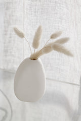 Ned Harmie Vase Pipi White matte ceramic bud vase styled with fluffy dried stems on a glass surface in soft natural light