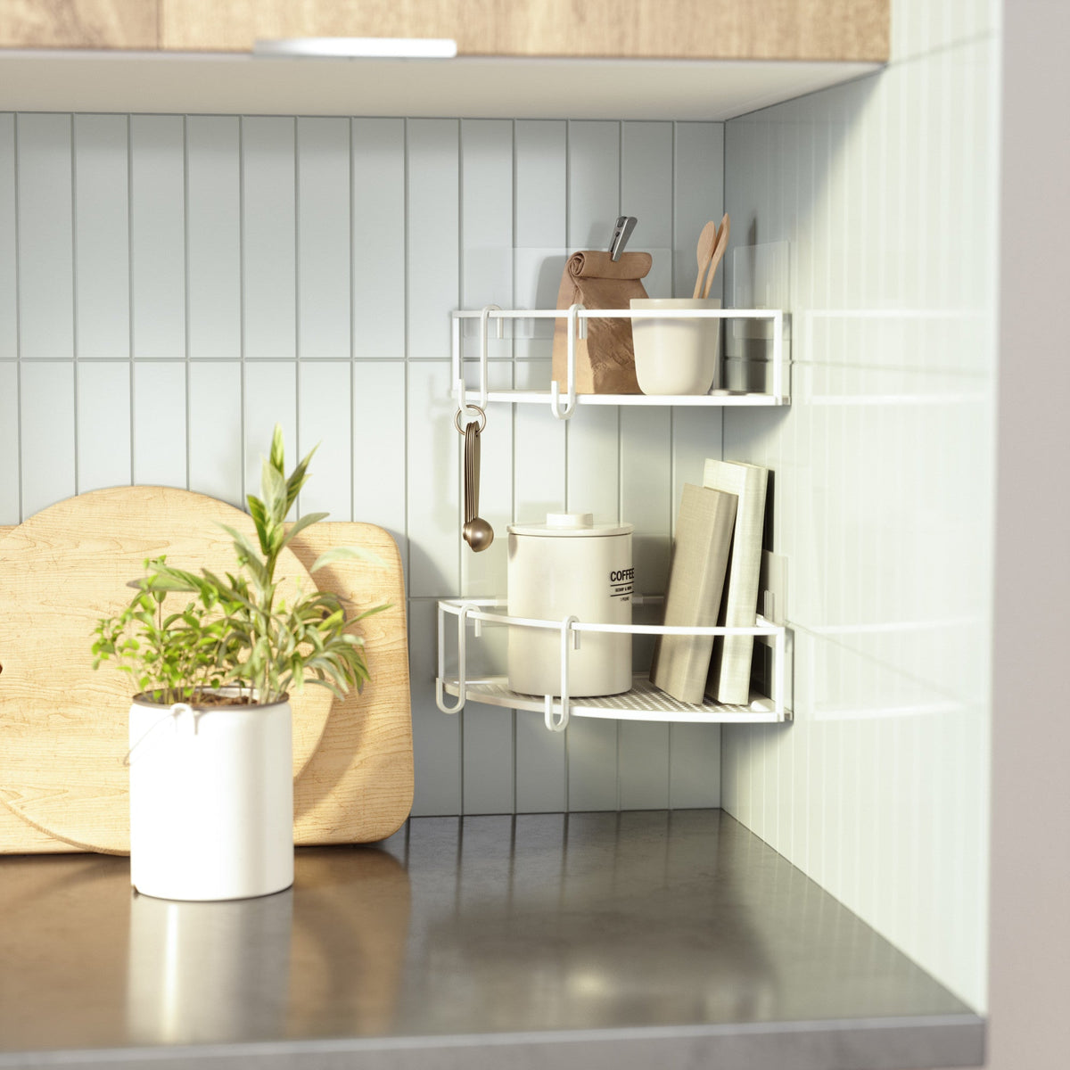 White Cubiko corner bins on a tiled kitchen wall holding utensils and a bottle