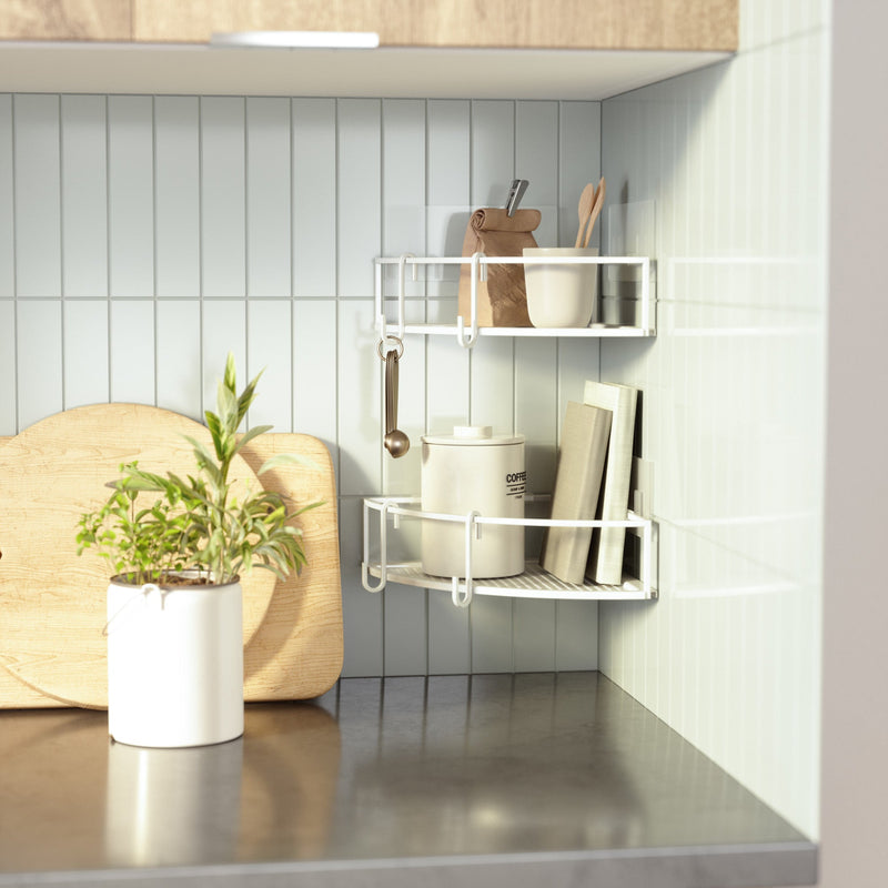 A kitchen shelf with the Umbra Cubiko Corner Bins, Set Of 2, potted plant and utensils made of rust-free metal.