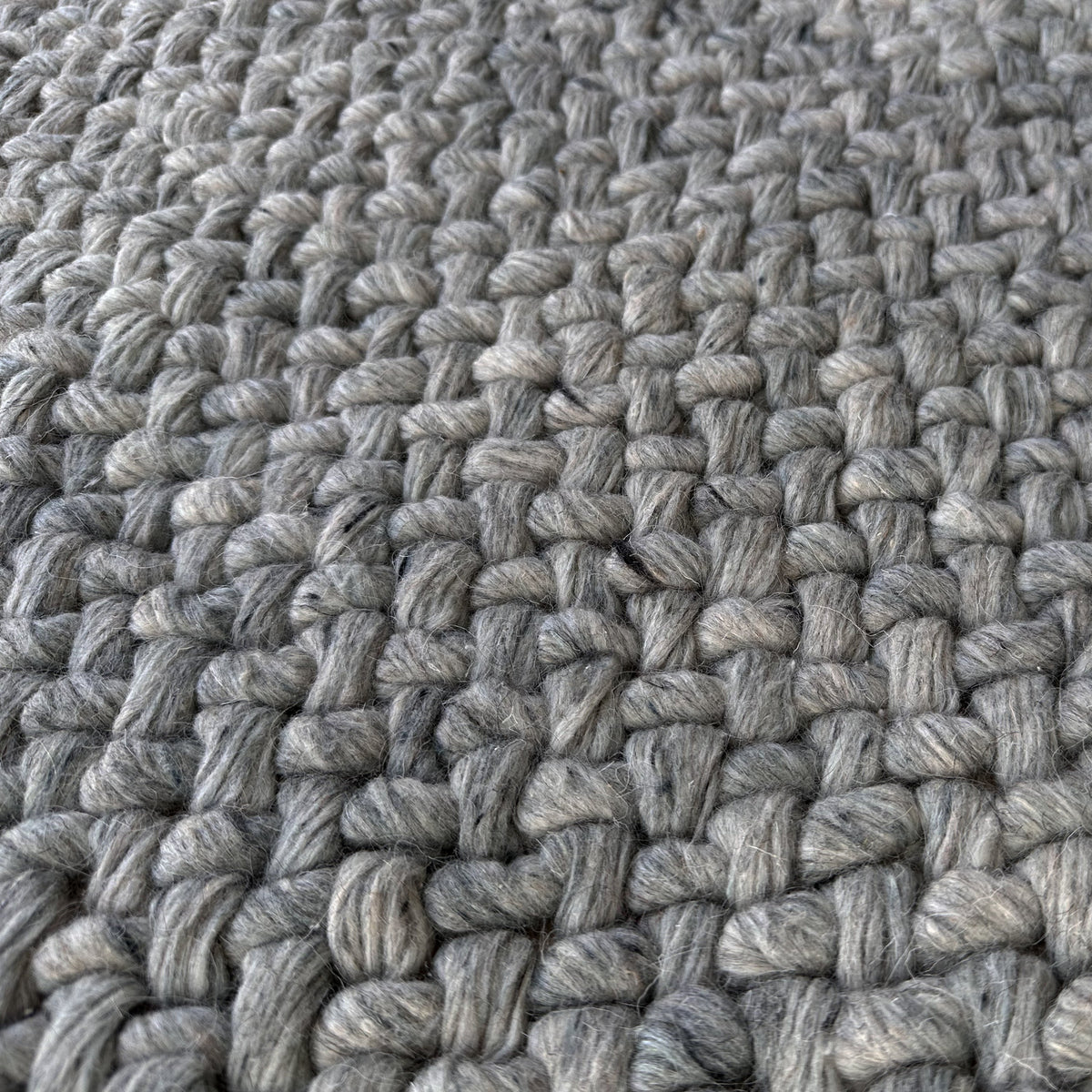 Close view of the braided grey loops in the chunky weave