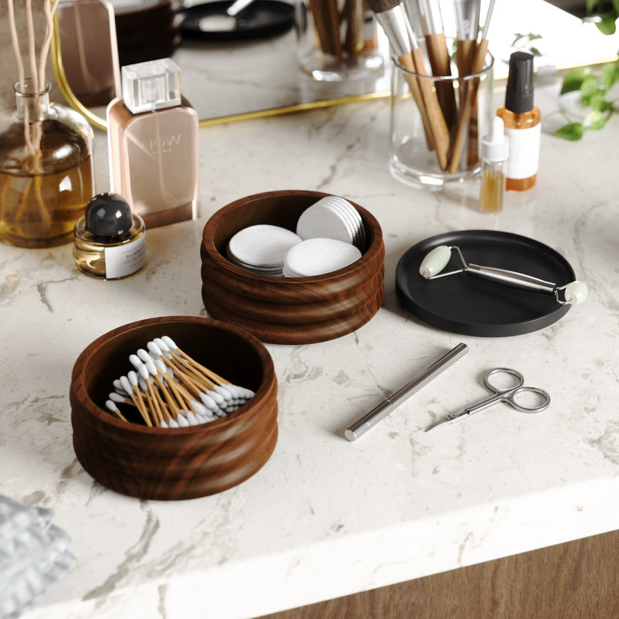 Umbra Tesora storage box in walnut open on a marble vanity with cotton buds and pads