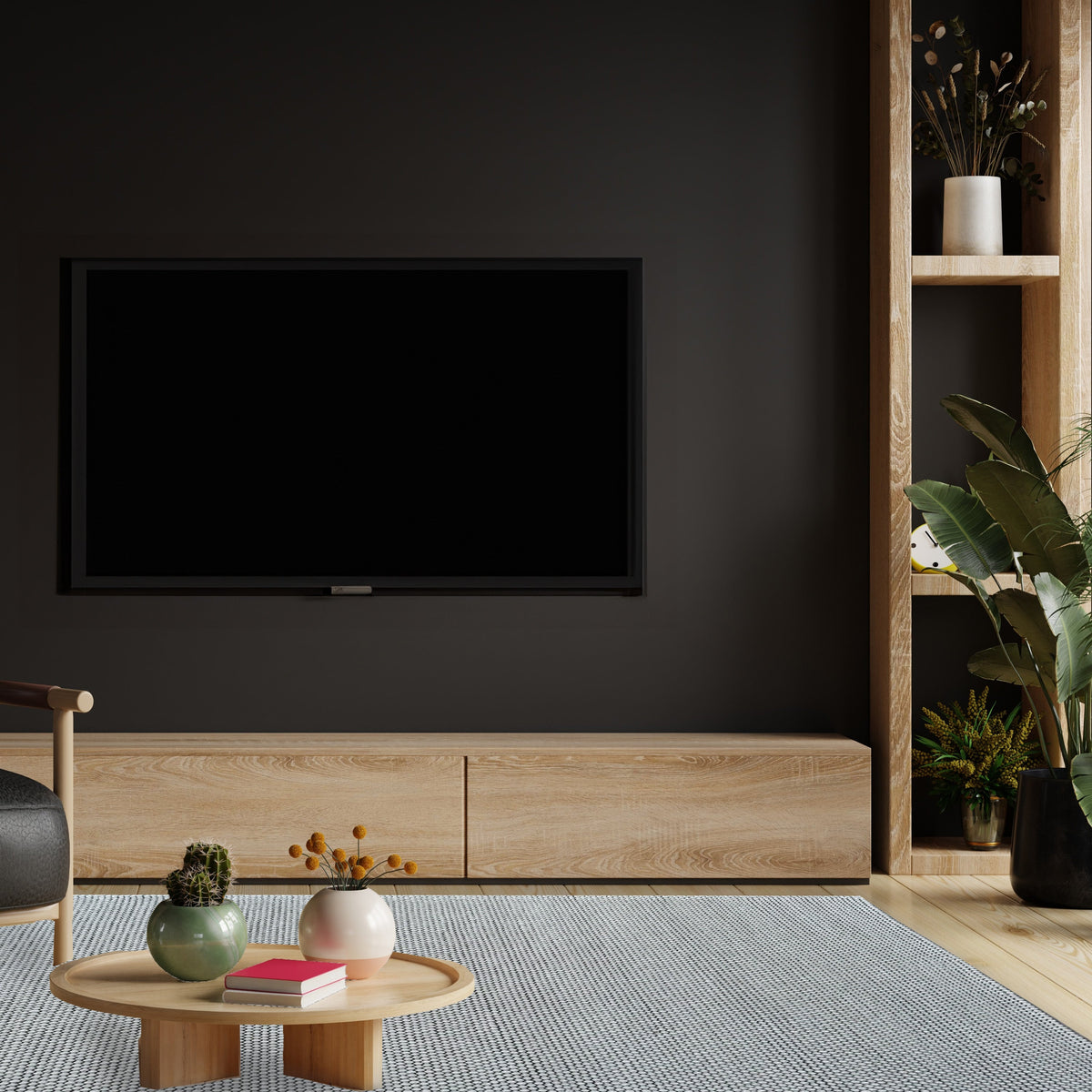 Grey loop rug in a media room with a dark feature wall, low timber cabinet and round coffee table