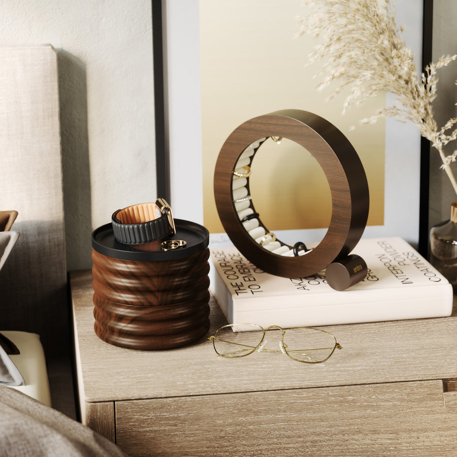 Umbra Tesora storage box in walnut on a bedside table beside a round jewellery stand