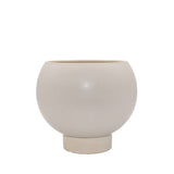 Neutral stoneware planter with curved silhouette and built-in plinth