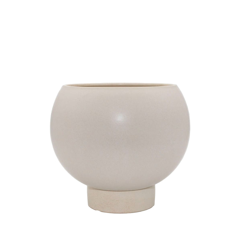 Neutral stoneware planter with curved silhouette and built-in plinth