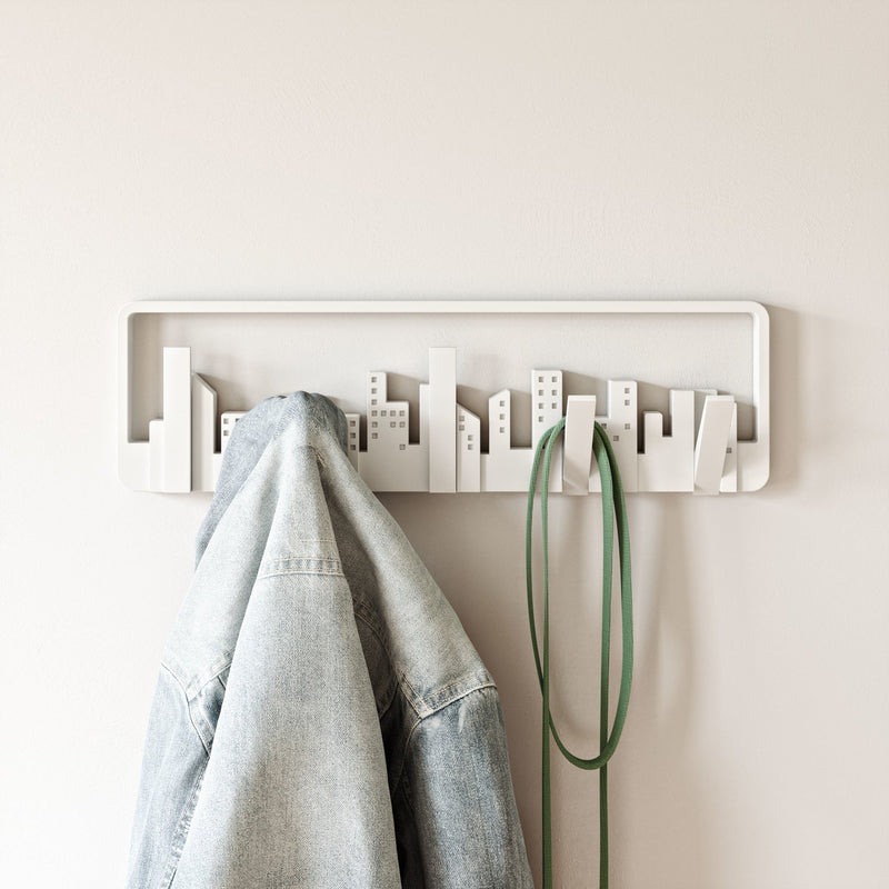 A white Skyline Wall Mounted Hook with a city design on it, featuring hooks for small spaces.