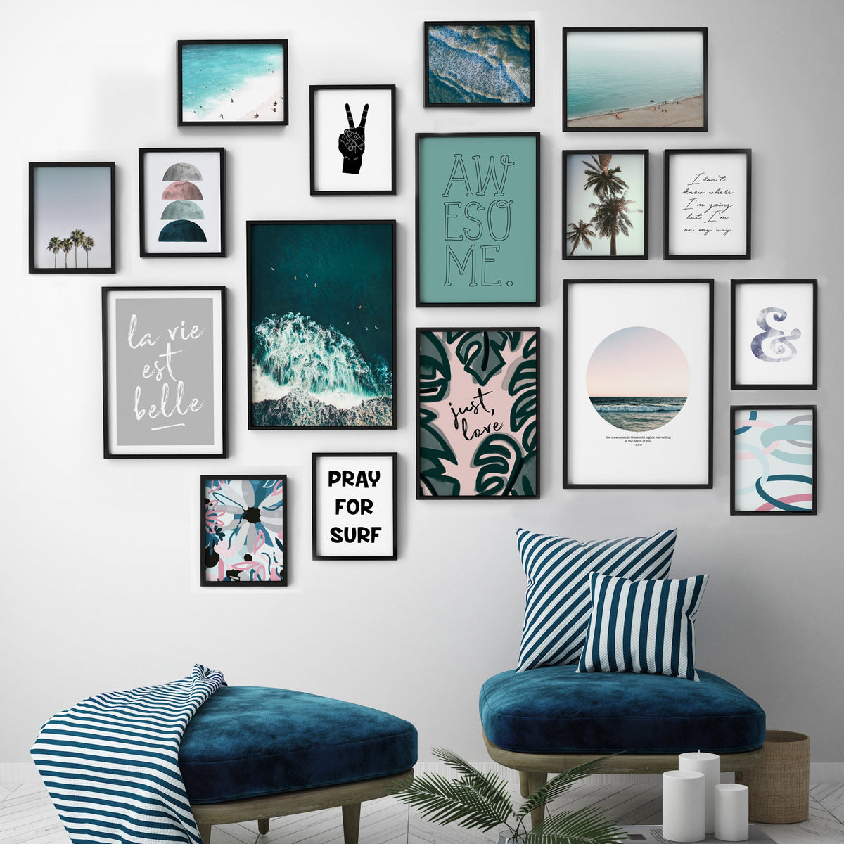 Pray For Surf print in a black frame within a coastal gallery wall above two navy velvet stools