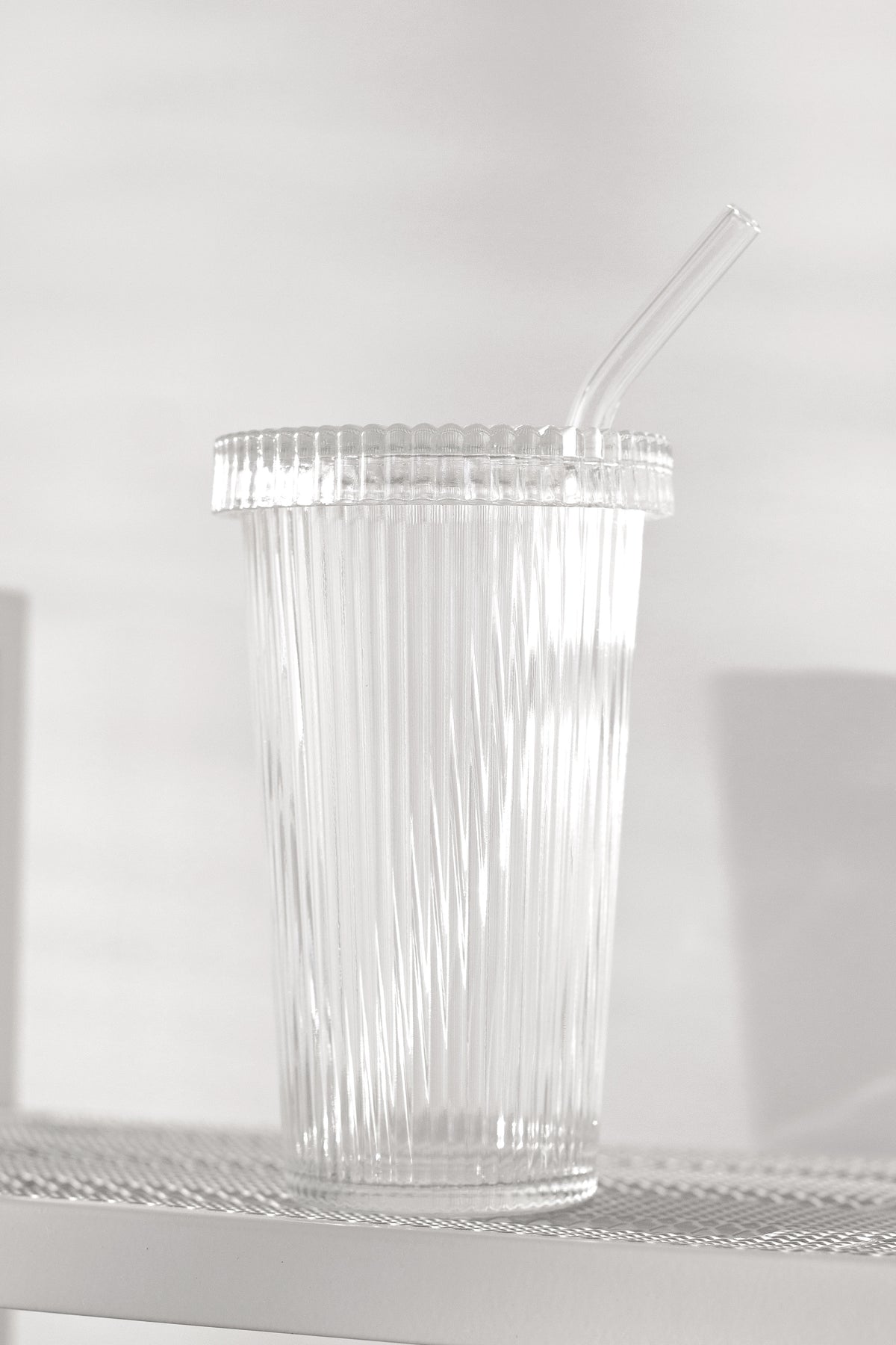Ribbed glass tumbler with lid and glass straw 320ml fluted iced coffee cup on neutral shelf