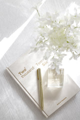 Rouge dry oil perfume mist inspired by Baccarat Rouge styled with neutral journal and gold pen