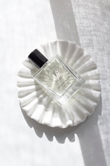 White ruffle ceramic tray styled with perfume bottle – sculptural catchall dish for jewellery, candles, and home styling.