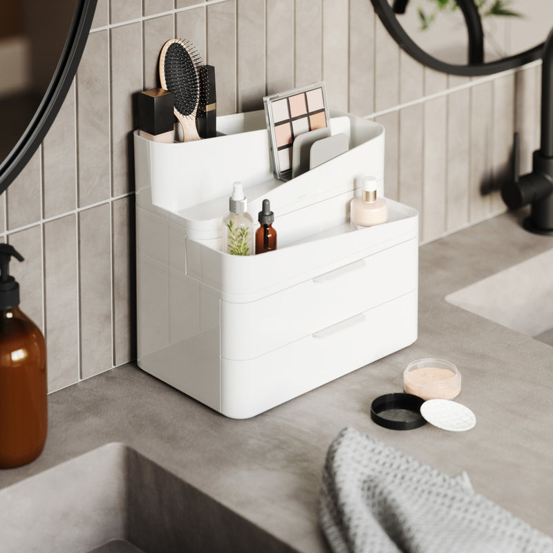 A Glam Cosmetic Organizer Large sitting on top of a mirror, creating a convenient beauty station. (Brand: Umbra)