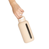 A person's hand holding a Day Bottle with Hydration Tracker - Various Options from Bink to track hydration and meet daily recommended water needs.