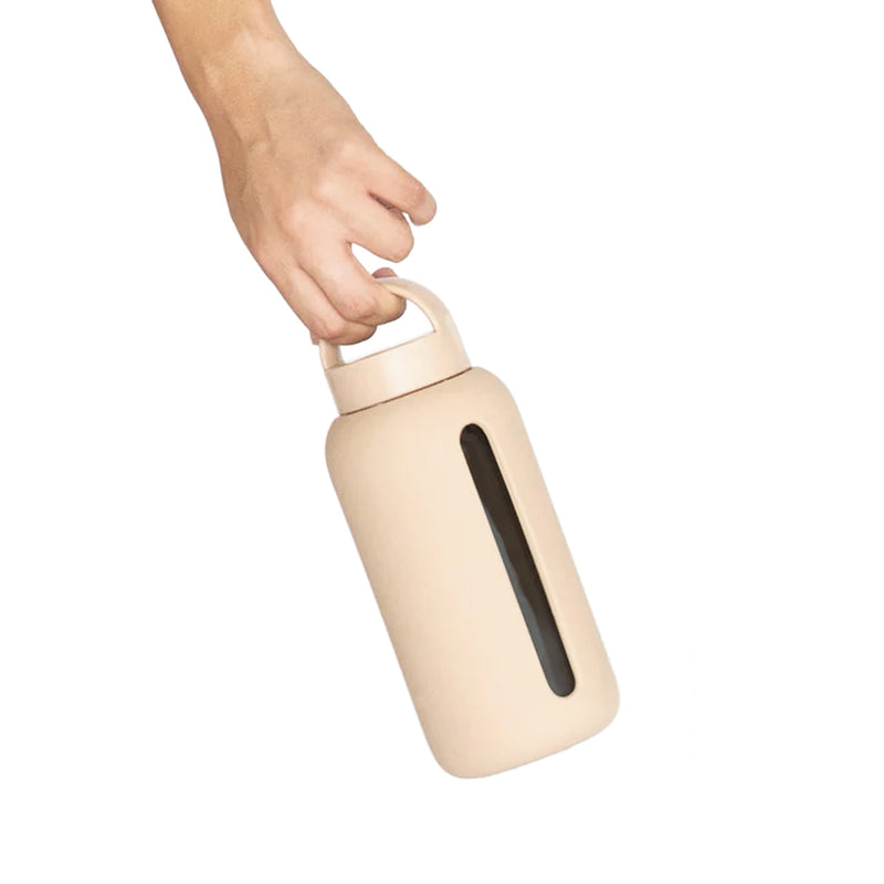 A person's hand holding a Day Bottle with Hydration Tracker - Various Options from Bink to track hydration and meet daily recommended water needs.