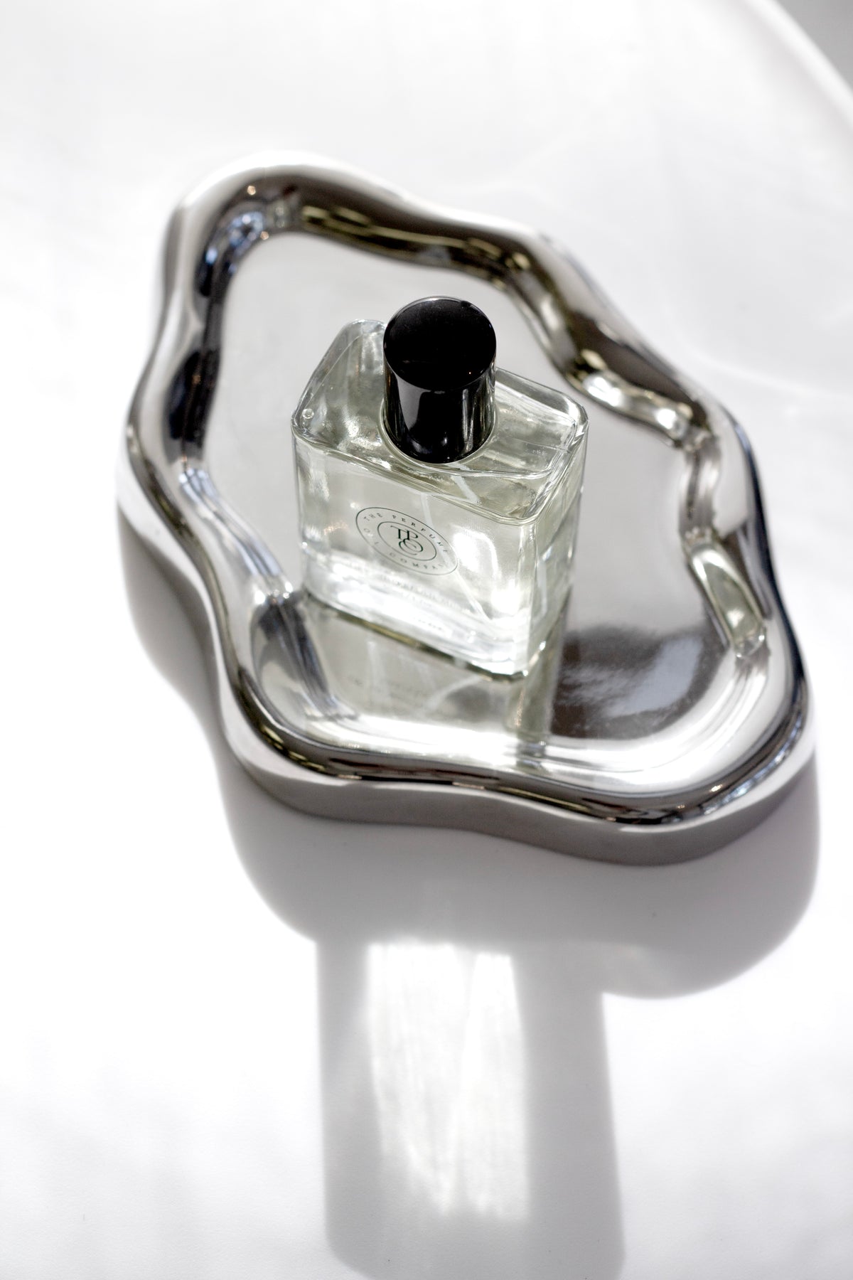 Silver cloud tray with perfume bottle modern sculptural decor styling