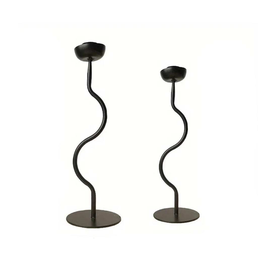 Two black Aries candle holders in taller and shorter heights, wavy stems on round disc bases