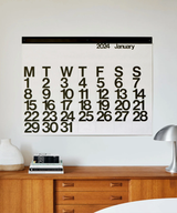 Stendig wall calendar displayed above a mid century timber sideboard