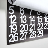 Stendig wall calendar hanging on a white wall showing alternating black/white months
