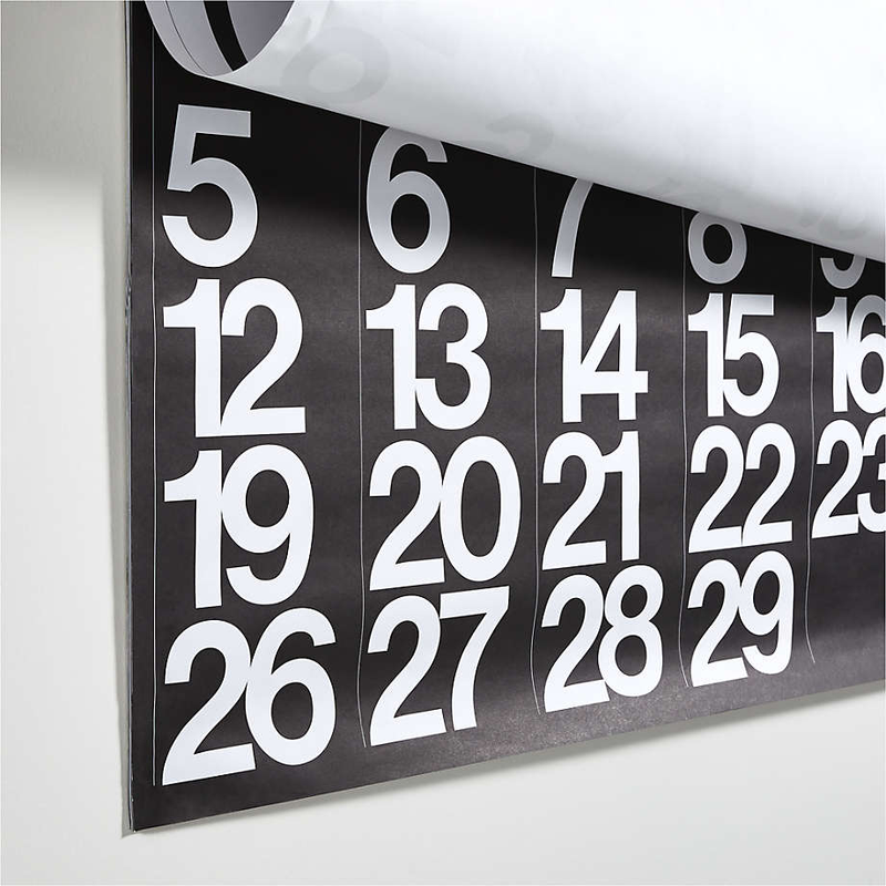 Stendig wall calendar hanging on a white wall showing alternating black/white months