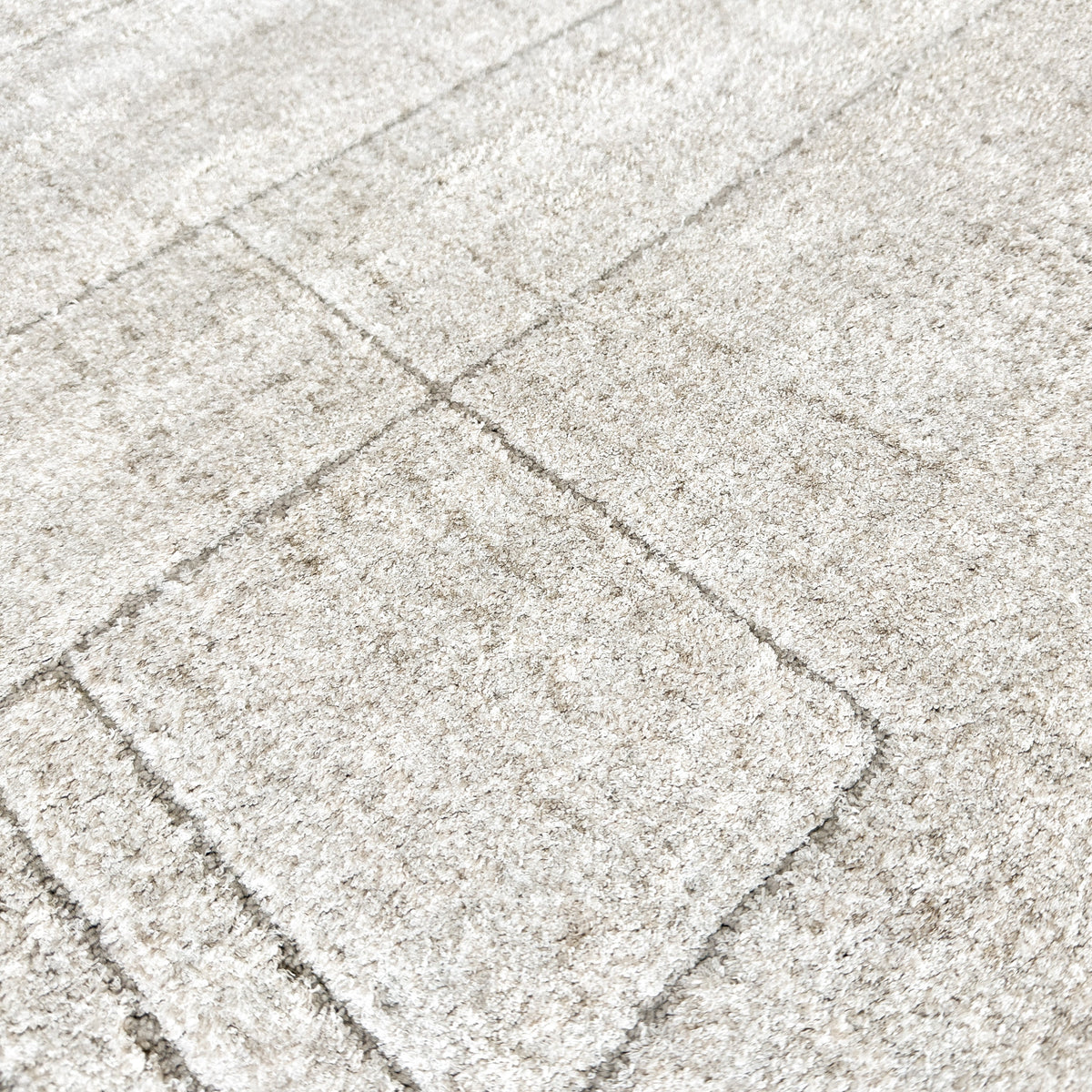 Close view of the soft beige pile with fine tonal lines