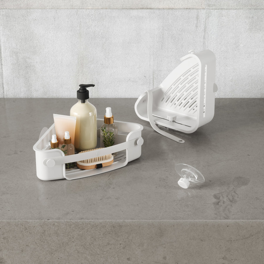 Umbra Flex corner bin in white with its drainage tray removed, adhesive disc beside it