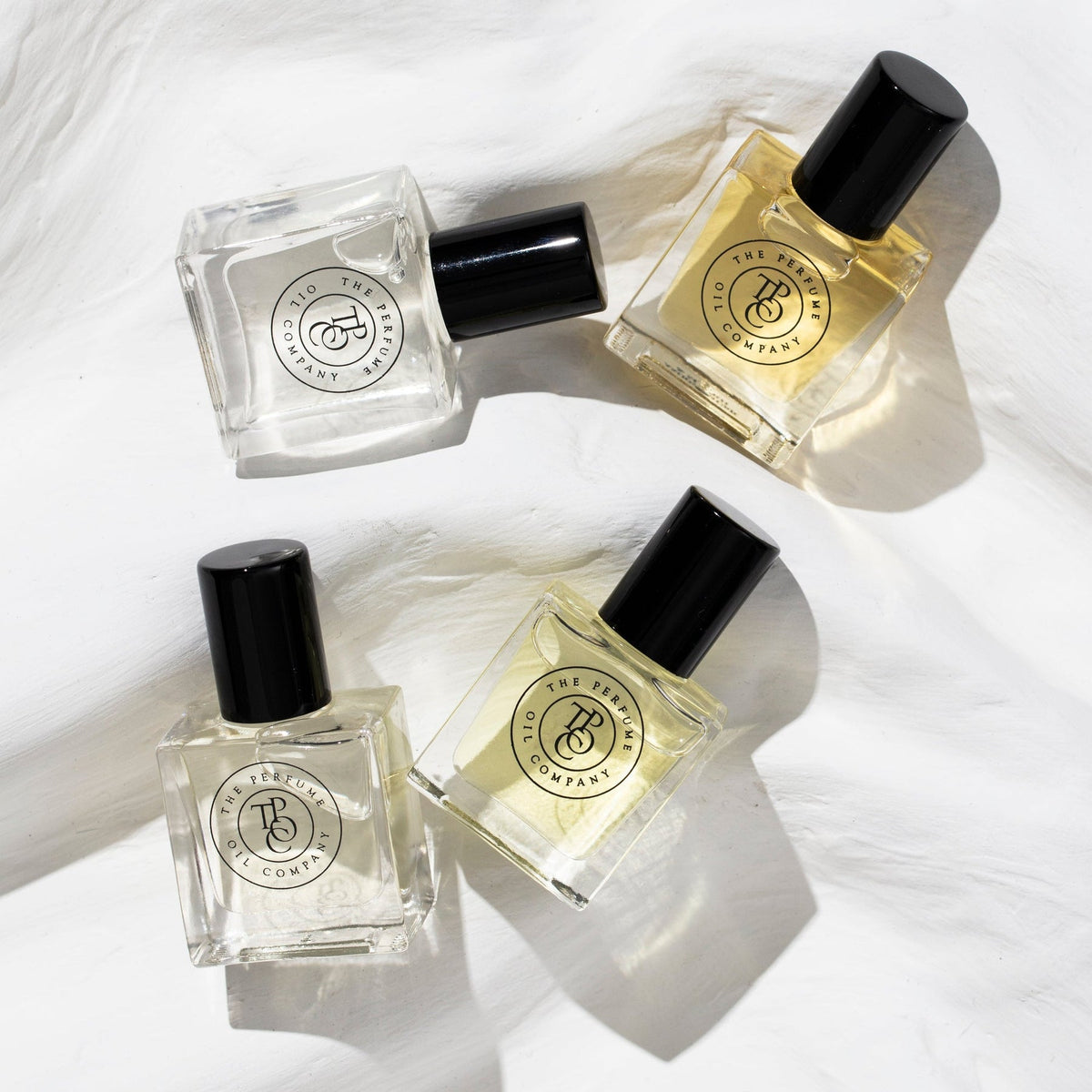 Her Perfume Oil Gift Set bottles arranged on a neutral surface