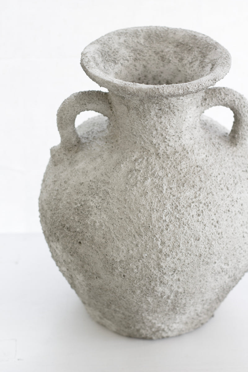Thira Vase with curved handles and textured stone surface, side view
