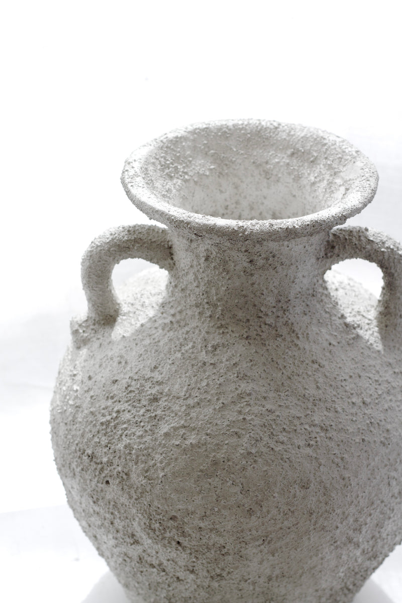 Close-up of Thira Vase handle and rim, showing weathered stone texture.
