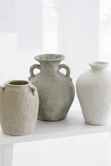 Thira Vase displayed with other vases in tonal grey and white palette