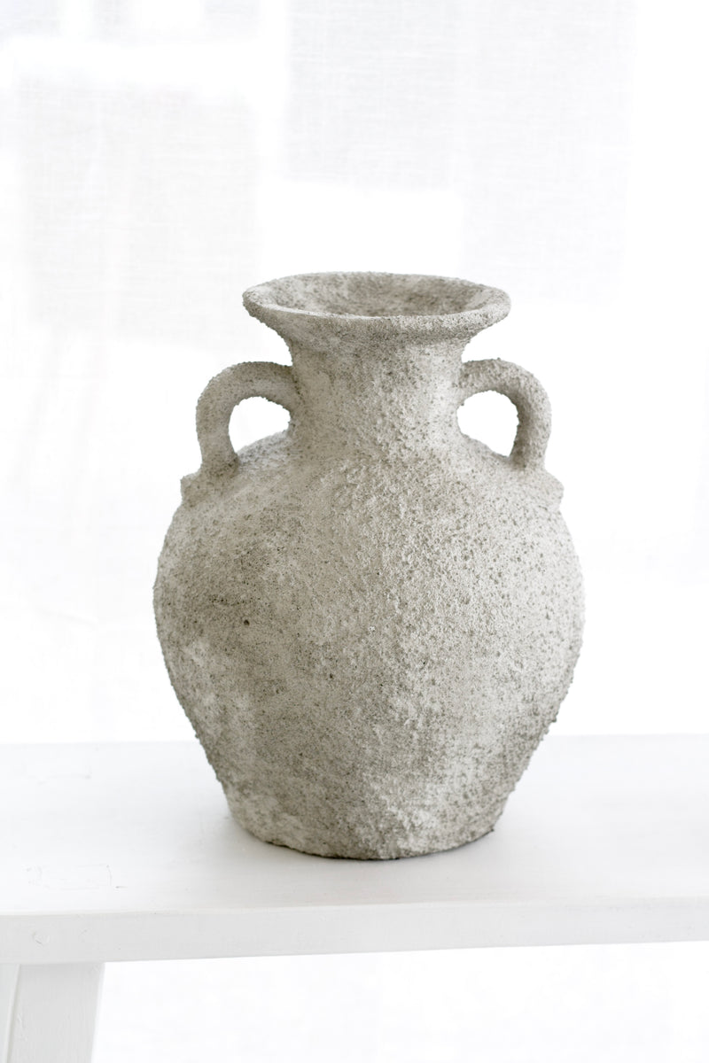 Sculptural Thira Vase styled on a white surface with soft grey light