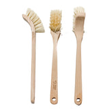 Three Good Change wooden dish brushes on a white kitchen bench
