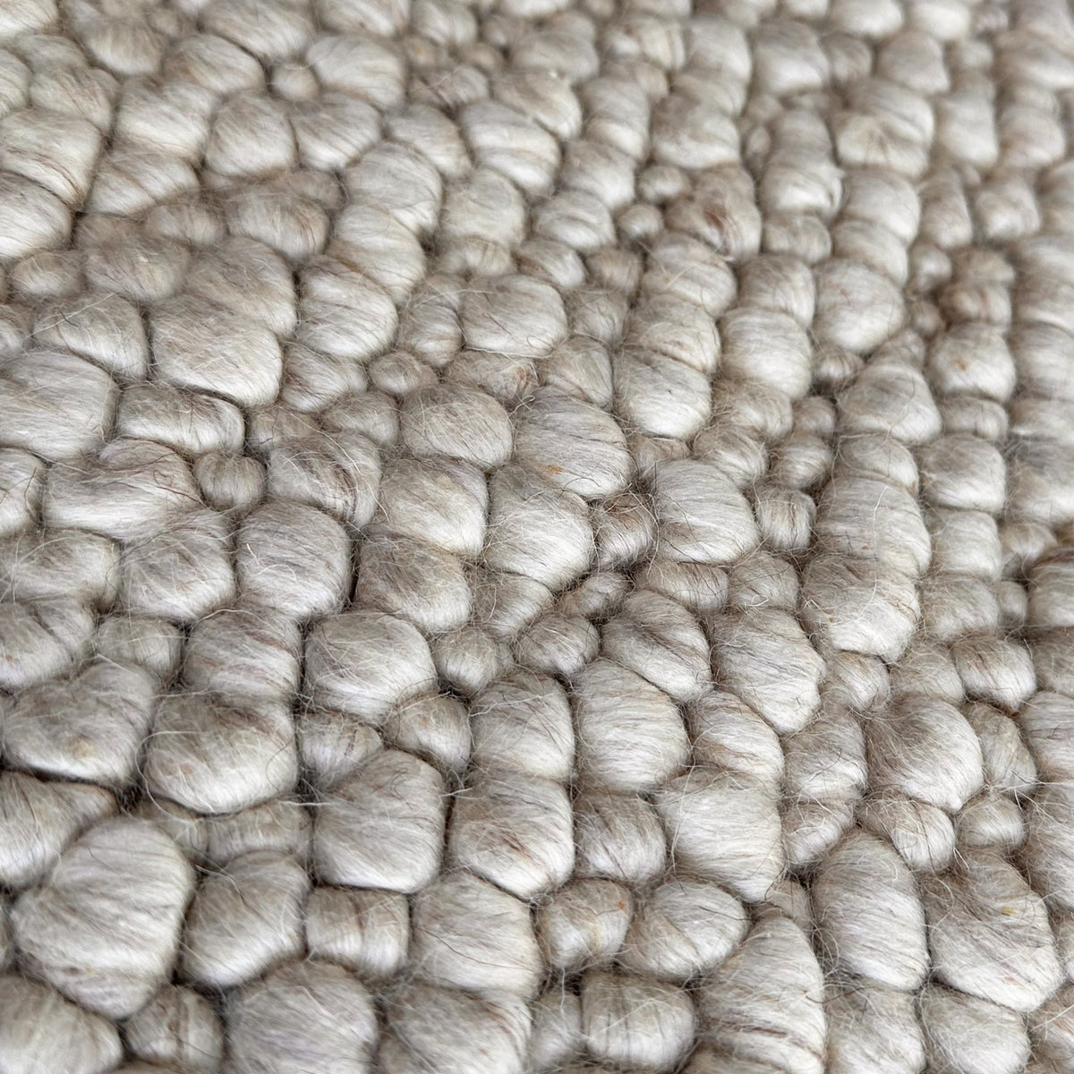 Close view of the rounded sand wool loops packed tightly together