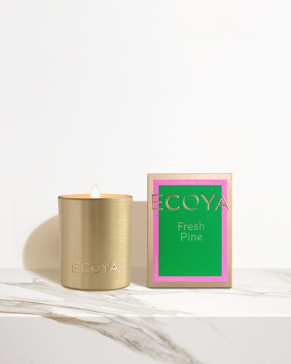 Holiday: Fresh Pine Mini Goldie Candle by Ecoya on a marble table, perfect for the festive season.