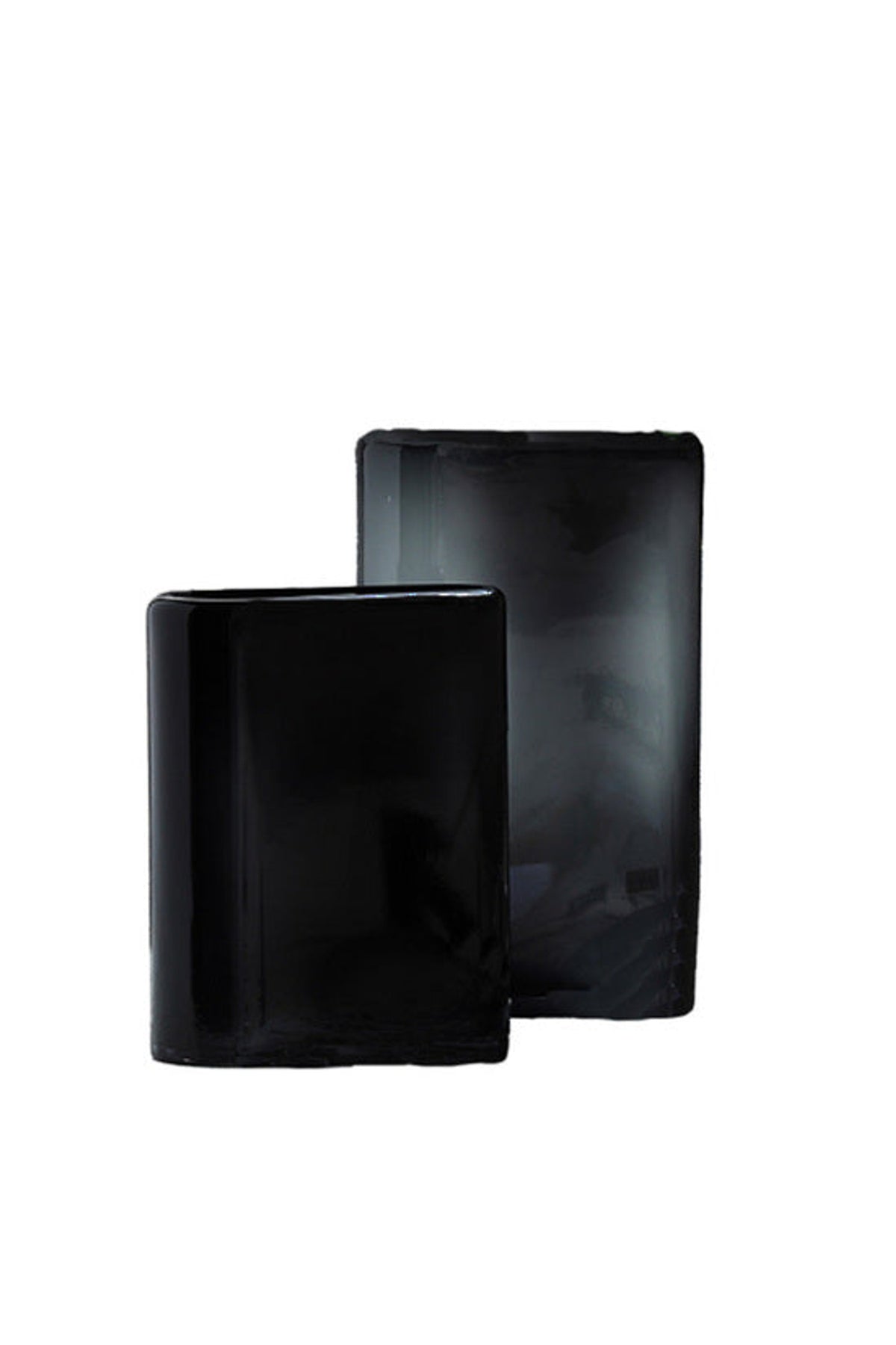 Wave Vases in black, two flat rectangular vessels with wavy rims, small in front
