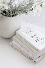 When You're Ready This Is How You Heal book stacked with neutral decor and flowers