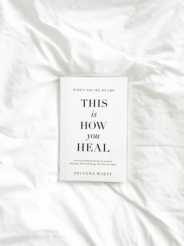 Brianna Wiest book When You’re Ready, This Is How You Heal styled on white linen bedding; self-growth and healing guide.