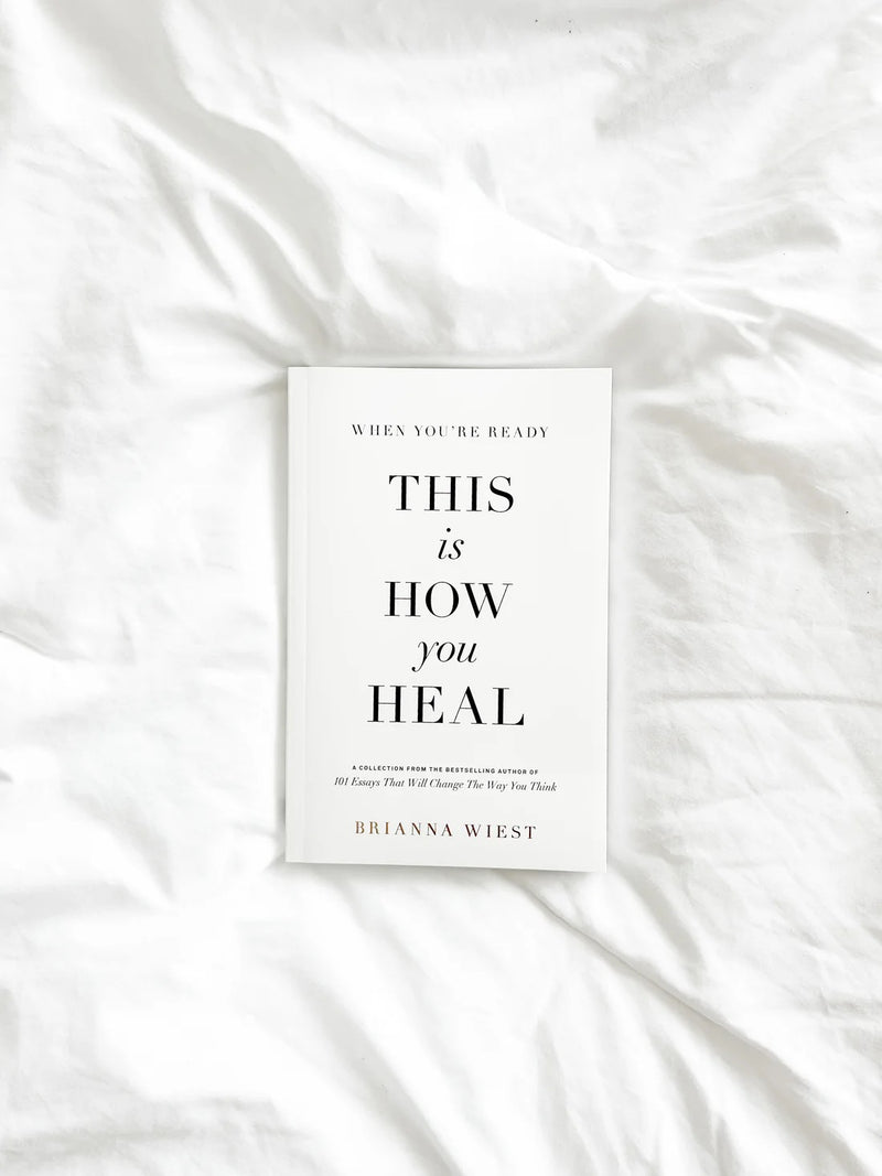 Brianna Wiest book When You’re Ready, This Is How You Heal styled on white linen bedding; self-growth and healing guide.