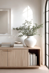 White ceramic urn vase styled on console with greenery – large sculptural decorative vase