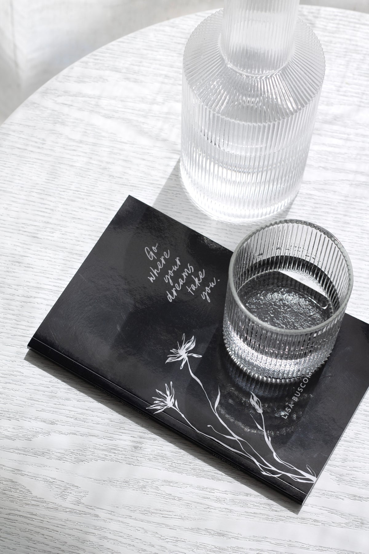 Wilde Road 'Go Where Your Dreams Take You' gift book of 200 reminders, elegant black cover styled on a bedside table