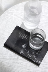 Wilde Road 'Go Where Your Dreams Take You' gift book of 200 reminders, elegant black cover styled on a bedside table
